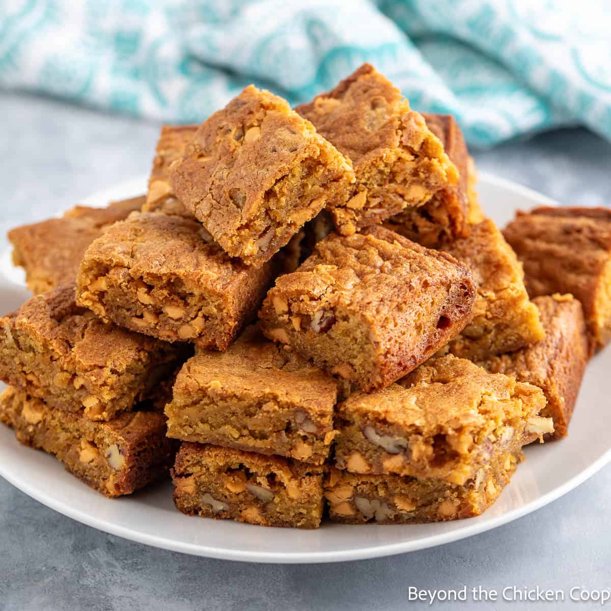 Butterscotch Brownies stacked on a white plate.