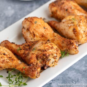 Baked Chicken Legs on a white platter.