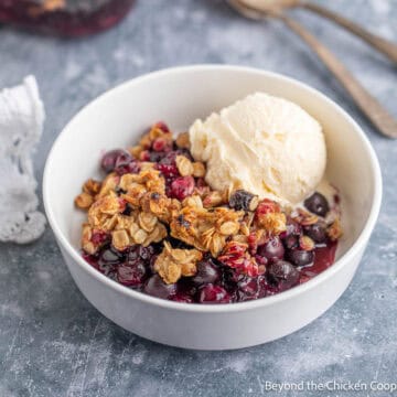 Blueberry Crisp in a bowl with a scoop of ice cream.